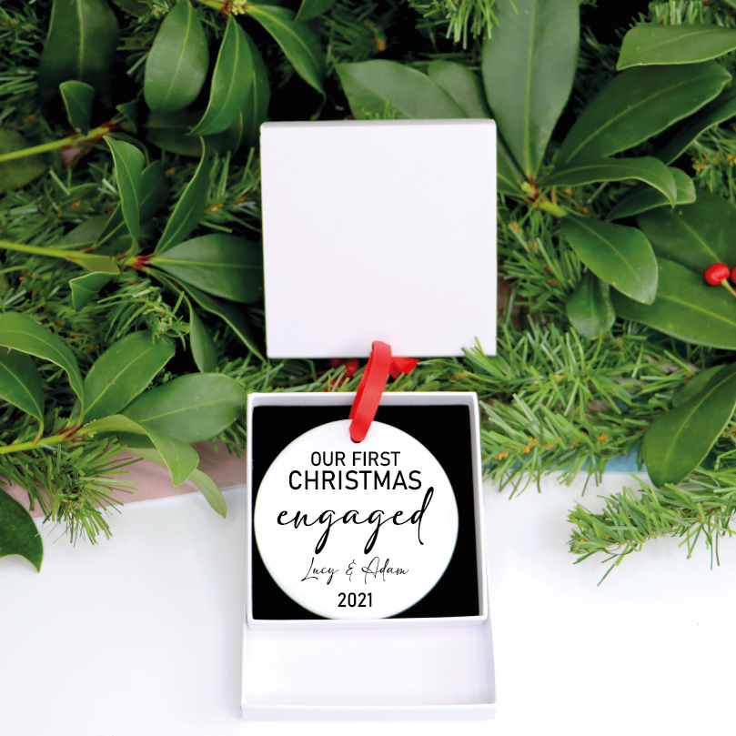 Our personalized ceramic ornament is perfect for all newly engaged to hang on their Christmas tree! This ornament is personalized with your names and year.